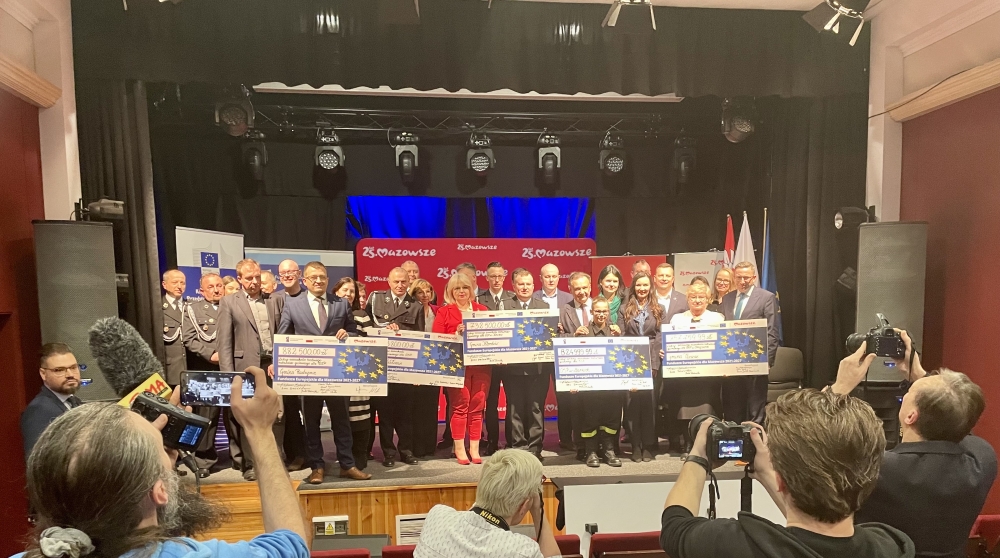 1. Pan Marszałek Adam Struzik, Pani Monika Tchórznicka – zastępca dyrektora ds. Europejskiego Funduszu Rozwoju Regionalnego w MJWPU, radna województwa Pani Anna Brzezińska oraz beneficjenci z czekami.